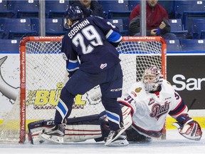 Regina Pats goalie Tyler Brown makes a pad save on Saskatoon Blades forward Nikita Soshnin during the shootout portion of their WHL game Sunday in Saskatoon.