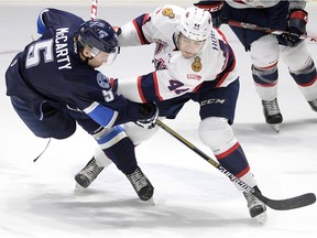 Connor Hobbs of the Regina Pats, right, battles with Mason McCarty of the Saskatoon Blades during Tuesday's Western Hockey League game at the Brandt Centre.