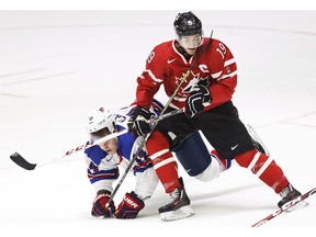 Canadian captain Brayden Point fights for the puck during Saturday's world junior opener against Team USA.