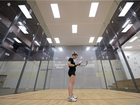 Christine Richardson examines her racquet at the Orr Centre's new racquetball courts, which were used at the 2015 Pan American Games.