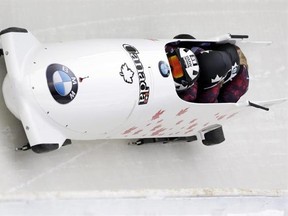 Driver Kaillie Humphries with Cynthia Appiah, Genevieve Thibault and brakeman Melissa Lotholz, of Canada, compete in the four-person bobsled World Cup race on Saturday, Jan. 9, 2016, in Lake Placid, N.Y. They became the first all-female team to compete in a four-person World Cup bobsled race at Mount Van Hoevenberg. (AP Photo/Mike Groll)