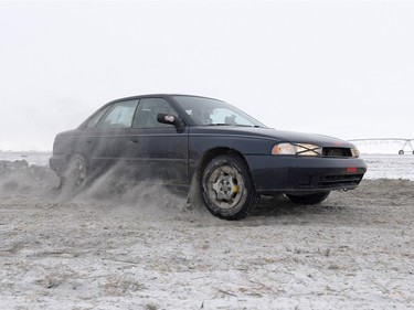 A car takes a corner during a Winter Rally X race held in a field south of Regina, Sask. on Sunday January 24, 2016. The group plans to run winter races until March.