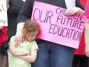 A woman puts her hand on a girls shoulder during an aboriginal protest against the First Nations Education act May 2014.