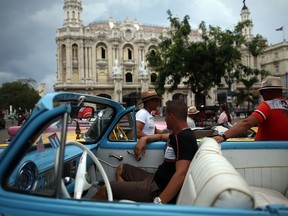 Taxi drivers chat around their vintage American cars on September 16, 2015 in Havana, Cuba.