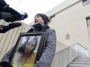 Delores Stevenson holds a portrait of her niece Nadine Machiskinic at a rally outside of the Regina Police Service building on Sunday, January 10, 2016.