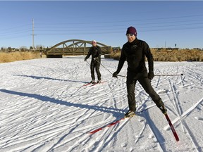Lorenzo Carani, left, and Lorne Sier, right, ski on Wascana Creek near Rainbow Bridge in Regina, Sask. on Saturday January 2, 2016. Michael Bell/Regina Leader-Post