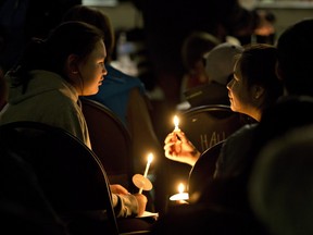 Members of the La Loche community hold a prayer vigil following a deadly shooting left four people dead.