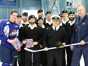 Members of the HMCS Regina crew meet with Regina Pats captain Adam Brooks, left, and head coach/GM John Paddock, right, on Monday in Everett, Wash.