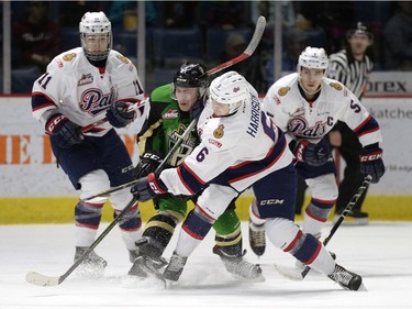 Regina Pats defence Chase Harrison (#6) takes the puck from Prince Albert Raiders forward Jordan Tkatch (#24) during a game held at the Brandt Centre in Regina on Sunday January 3, 2016.