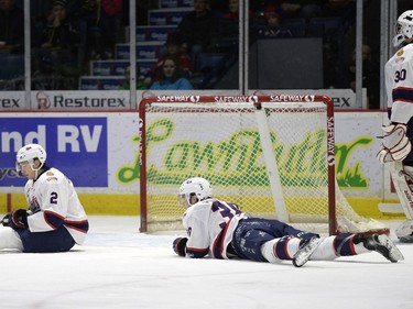 Regina Pats defence Sergey Zborovskiy (#2) and forward Brady Pouteau (#38) lay on the ice after a Prince Albert Raiders goal during a game held at the Brandt Centre in Regina on Sunday January 3, 2016.