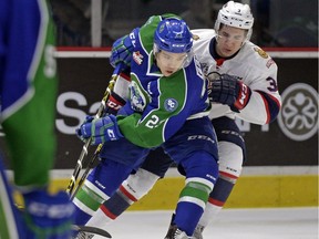 Regina Pats defenceman James Hilsendager, right, pursues Swift Current Broncos forward Scott Feser during Friday's WHL game at the Brandt Centre.