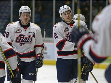 Regina Pats forward Aaron Macklin (#18) and defence Sergey Zborovskiy (#2) return to the bench after a Prince Albert Raiders goal during a game held at the Brandt Centre in Regina on Sunday January 3, 2016.