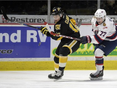 Regina Pats forward Adam Brooks (77) and Brandon Wheat Kings defence Kale Clague (10) battle for the puck during a game at the Brandt Centre in Regina, Sask. on Sunday January 24, 2016.