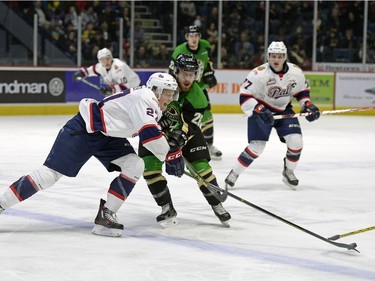 Regina Pats forward Austin Wagner fights for the puck against the Prince Albert Raiders foward Kolten Olynek at the Brandt Centre in Regina, Sask. on Saturday January 23, 2016.