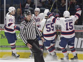 The Regina Pats' Jared McAmmond, directly to the right of the linesman, celebrates his first goal of the season Sunday against the visiting Prince Albert Raiders.