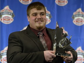 Former University of Regina Rams and Calgary Stampeders standout Brett Jones, shown here receiving the CFL's most-outstanding-rookie award in 2013, is waiting to hear what his future is with the NFL's New York Giants.
