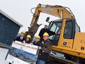 Mark Allan (top), Regina Exhibition Association Limited CEO, along with (L-R) Mayor Michael Fougere, Regina Hotel Association CEO Tracy Fahlman, Canadian Western Agribition president Stewart Stone and  Agriculture Minister  Lyle Stewart beside a large Silverado Demolitions backhoe before demolition starts at Evraz Place on Jan. 7.