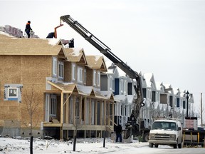 Crews work on multi-unit housing in Harbour Landing in Regina on Monday. Housing starts in 2015 were the lowest in five years.