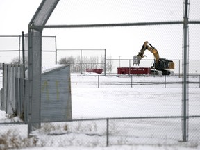 A trackhoe works on the demolition of Pacer Park ball diamonds in Regina on Monday.