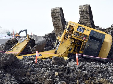 An excavator toppled over while working on the Regina Bypass project just east of Tower Road on the south side of the Trans-Canada Highway on Monday, Jan. 25, 2016.