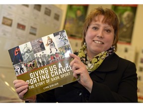 Author Lynn Gidluck is shown Thursday with a copy of her book on the history of Sask Sport Inc.