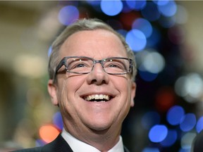 Why is this man smiling?  Premier Brad Wall says Saskatchewan will continue to attract people, jobs and investment in 2016. What does he know that we don't?