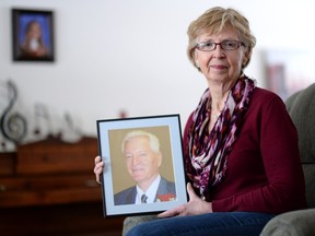 Myrna Switzer holds a photo of her late husband who died two years ago after an agonizing battle with Alzheimer's disease.