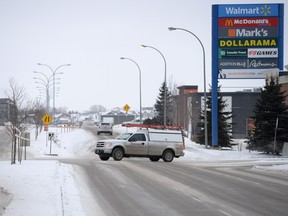 Traffic turning westbound onto Rochdale Blvd. with the Hawkstone neighbourhood in the background.