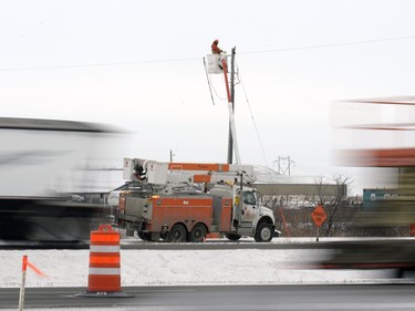 SaskPower crews were out on the Trans-Canada Highway east of Tower Road near a CP railway bridge starting their work Monday morning.