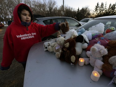 Eight year old Laila LaFramboise brought teddy bears to leave at the vigil. A candlelight vigil for La Loche was held in Regina Wednesday night .