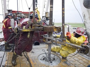 Workers on a drilling rig on a oil well in near Weyburn. The number of active rigs in the province is down 27 per cent from this time last year.