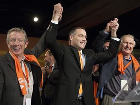 Former Saskatchewan NDP premiers Lorne Calvert (left) and Roy Romanow (right) were on hand to congratulate Cam Broten when he won the NDP leadership in 2013. Broten and his party faces a tough test in the April 4 provincial election.