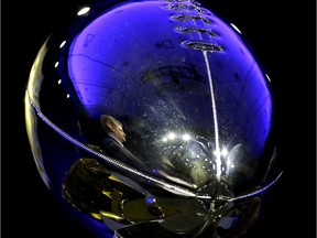 NFL Commissioner Roger Goodell is reflected in the Lombardi Trophy as he speaks to the media during a news conference Friday, Feb. 5, 2016, in San Francisco. (AP Photo/Charlie Riedel)