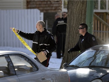 A Regina Police Services member begins to tape-off an area where a woman was allegedly stabbed at 1145 Robinson St. in Regina on Tuesday Feb. 23, 2016.