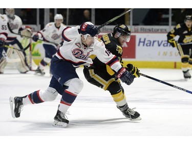 Brandon Wheat Kings defence Macoy Erkamps (20) and Regina Pats forward Aaron Macklin (18) bump during a game held at the Brandt Centre in Regina on Saturday Feb. 13, 2016.