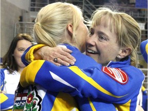 Alberta third Amy Nixon, right, celebrates with lead Laine Peters on Sunday after helping their Chelsea Carey-skipped team win the Scotties Tournament of Hearts title.