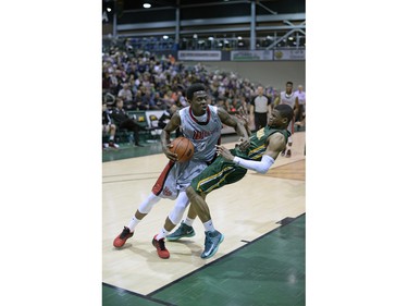Cougars guard Jonathan Tull is fouled by Wesmen guard Denzel Lynch-Blair during a playoff game held at the University of Regina on Saturday Feb. 27, 2016.