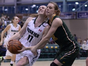 University of Regina Cougars guard Kehlsie Crone (8) was whistled for a foul on University of Saskatchewan Huskies guard Laura Dally during Saturday's game at the University of Regina.
