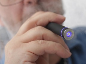 A smoker using an electronic cigarette, which health groups want banned from places in Saskatchewan that already ban regular smoking.