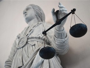 A statue of the goddess of Justice balancing the scales.