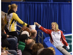 Jennifer Jones of Team Canada makes a donation to the Sandra Schmirler Foundation during a break in the semifinal at the Scotties Tournament of Hearts in Grande Prairie, Alta., on Saturday.