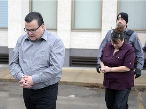 Kevin Goforth, left, and Tammy Goforth, right, are led away from the Court of Queen's Bench in Regina on Saturday Feb. 6, 2016.