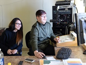 Grade 11 student Kayla Ponicappo, left,  and Grade 10 student Jazz Moise work as DJs at CHPN-FM in La Loche on Tuesday.