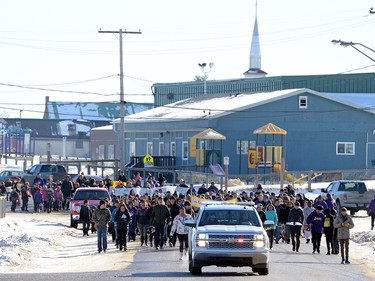 Community members take part in the Reclaiming Our School walk in La Loche  on Wednesday.