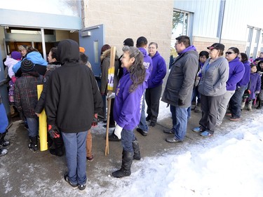Community members take part in the Reclaiming Our School walk in La Loche  on Wednesday.