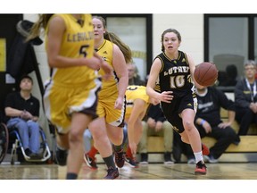 Luther Lions guard Maddie Tell, 10, brings up the ball against the LeBoldus Golden Suns during the senior girls final at the Luther Invitational Tournament  on Saturday.
