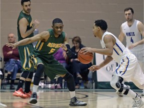 University of Regina Cougars guard Brandon Tull, 5, is shown playing defence against the visiting Victoria Vikes in Canada West men's basketball action Saturday.