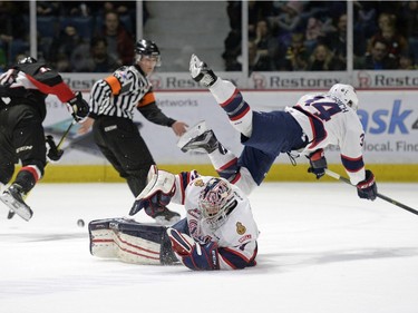 Regina Pats defence Jared Freadrich (34) jumps over goalie Tyler Brown (31) during a game held at the Brandt Centre in Regina on Saturday Feb. 6, 2016. MICHAEL BELL
