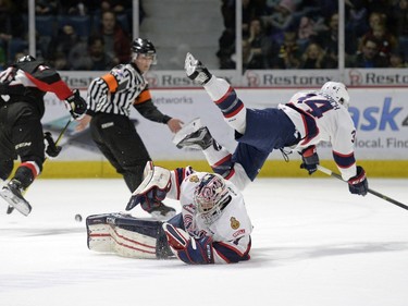 Regina Pats defence Jared Freadrich (34) jumps over goalie Tyler Brown (31) during a game held at the Brandt Centre in Regina on Saturday Feb. 6, 2016.