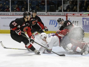 Regina Pats forward Sean Richards (15) runs into Prince George Cougars goalie Nick McBride (33) while teammate Tate Olson (25) hits the brakes during a game held at the Brandt Centre in Regina on Saturday Feb. 6, 2016. MICHAEL BELL